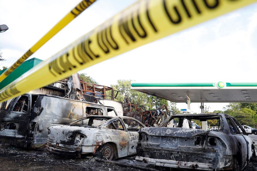 A gas station is seen burned down after disturbances following the police shooting of a man in Milwaukee, Wisconsin, U.S. August 14, 2016. REUTERS/Aaron P. Bernstein