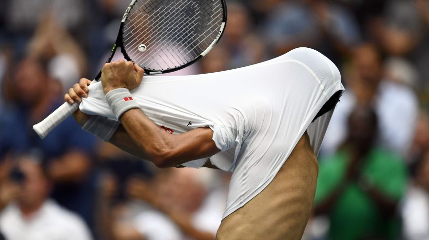 Novak Djokovic of Serbia takes off his shirt after losing a set against Gael Monfils of France during their 2016 US Open Men?s Singles semifinal match at the USTA Billie Jean King National Tennis Center in New York on September 9, 2016.  / AFP / Jewel SAMAD