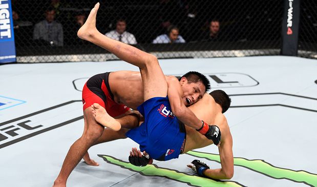 MEXICO CITY, MEXICO - NOVEMBER 05:  (L-R) Enrique Barzola of Peru takes down Chris Avila of the United States in their featherweight bout during the UFC Fight Night event at Arena Ciudad de Mexico on November 5, 2016 in Mexico City, Mexico. (Photo by Jeff Bottari/Zuffa LLC/Zuffa LLC via Getty Images)