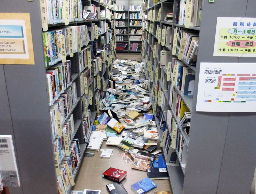 Books are scattered on the floor at a library in Iwaki, Fukushima prefecture Tuesday, Nov. 22, 2016 after a strong earthquake. A powerful earthquake off the northeast Japanese shore Tuesday sent residents fleeing to higher ground and prompted worries about the Fukushima nuclear power plant destroyed by a tsunami five year ago. (Kyodo News via AP)