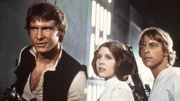 In this 1977 image provided by 20th Century-Fox Film Corporation, from left,  Harrison Ford, Carrie Fisher, and Mark Hamill are shown in a scene from 