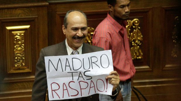 A deputy of the Venezuelan coalition of opposition parties (MUD) holds a placard that reads 