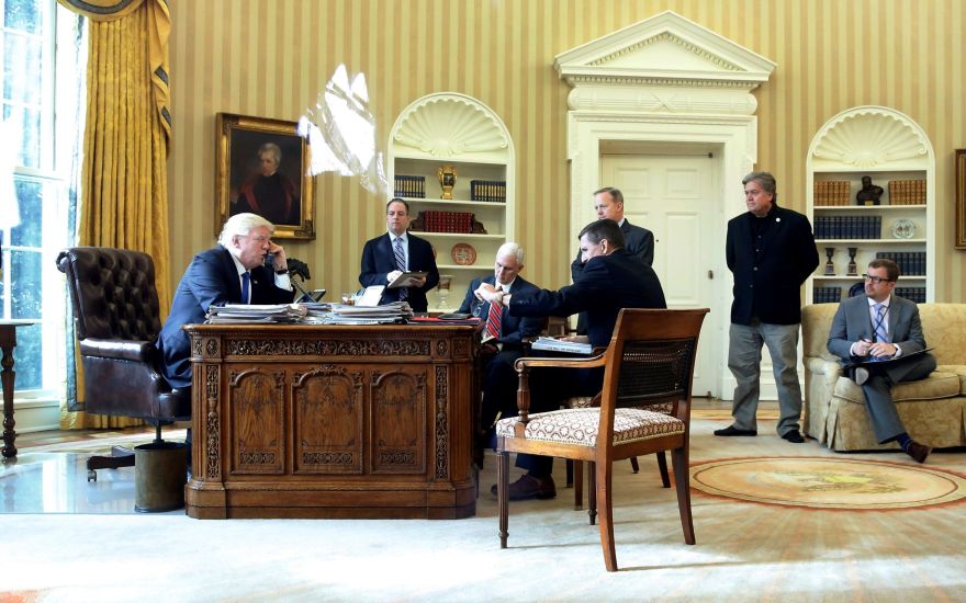 U.S. President Donald Trump (from L), joined by Chief of Staff Reince Priebus, Vice President Mike Pence, National Security Advisor Michael Flynn, Communications Director Sean Spicer and senior advisor Steve Bannon, speaks by phone with Russia's President Vladimir Putin in the Oval Office at the White House in Washington, U.S. January 28, 2017. REUTERS/Jonathan Ernst